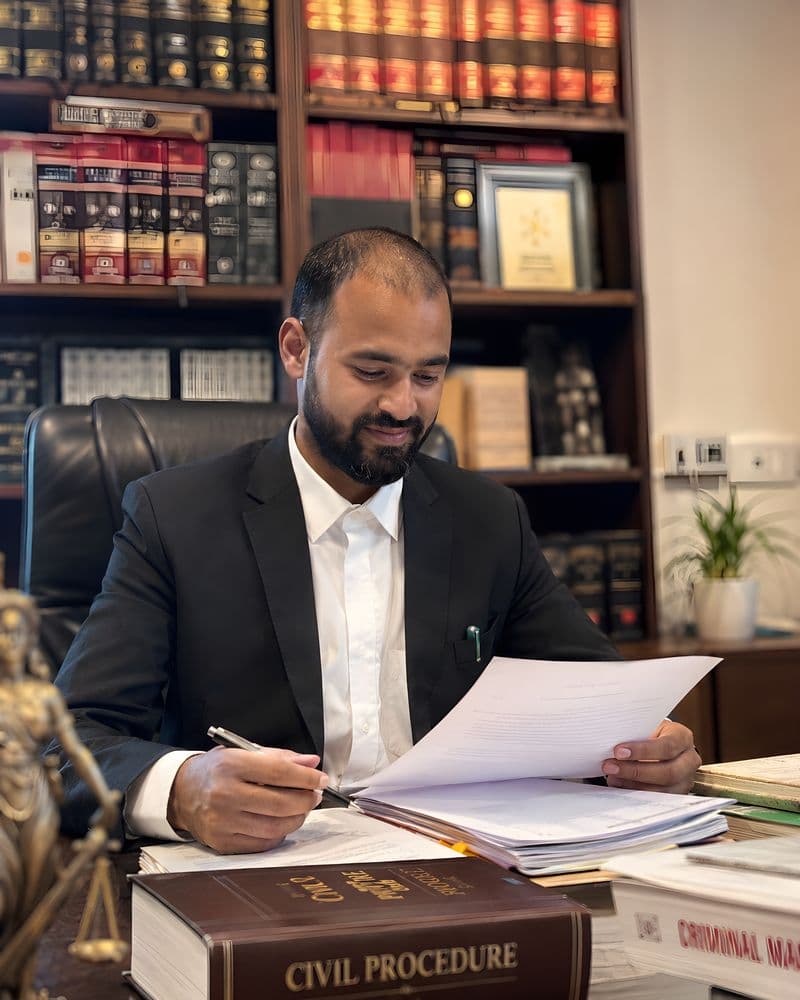 Rajender Prajapat at his desk in chambers, reading a brief